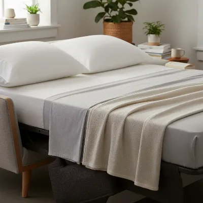 A close-up of the Burrow Nomad Sleep Kit, showing a memory foam pad and bedding laid out on the sofa, ready for sleeping.