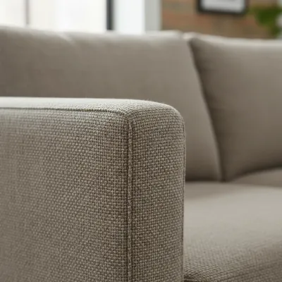Close-up of the fabric texture and stitching detail on the armrest of the CB2 Movie Sleeper Sofa, showcasing its modern design and material quality