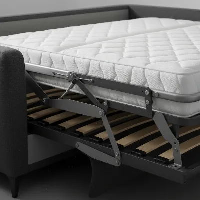 A close-up shot of a modern heavy-duty sleeper sofa's smooth, robust conversion mechanism, showing the steel frame and mattress support system. 