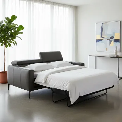 A sleek, modern leather sleeper sofa in a minimalist living room, transforming into a bed